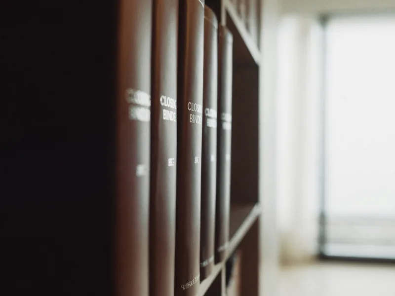 A shelf of closing binders receding into soft focus